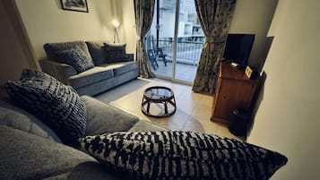 Flat-screen TV, DVD player, books, music library