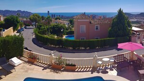 A pool area with a view of a cityscape and the sea. - Spacious modern villa - fabulous sea views, free WIFI, beach & golf (Golf Bahía)