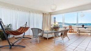 Un grand balcon doté d’un espace repas, d’un hamac et offrant une vue sur le paysage.