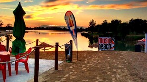Enjoy music and relaxation at Music Beach, where a serene lakeside setting awaits.