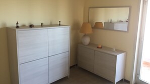 A bathroom with a large cabinet, a smaller vanity, a mirror, and a lamp. - Panoramic studio next to the beach (Giardini Naxos)