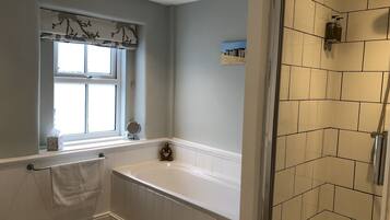 Bathtub, hair dryer, towels, soap