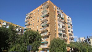 A multi-story residential building with balconies, a brick facade, and surrounding greenery. - Studio Apartment, Sleeps 2. Centrally located & close to all amenities. (Benalmádena)
