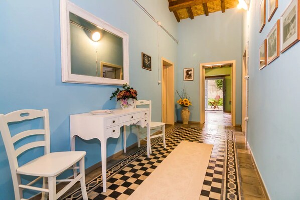 A hallway with a checkered floor, a white vanity with a mirror, a white chair, and a vase with flowers. - Ancient home of Pomegranate (Nurachi)