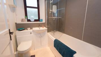 Combined shower/bathtub, hair dryer, towels, soap