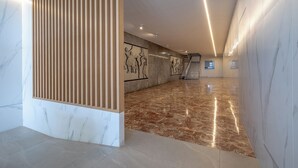 A spacious hallway with marble flooring, a wooden partition, and artwork on the walls. - Apartment/ flat - Cullera (Cullera)