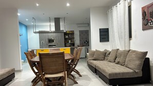 A modern living room with a sofa and dining table. - Villa With Pool Near The Sea.Syracuse, Plemmirio, Arenella,Fontane Bianche  (Siracusa)