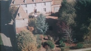 An aerial view of a large, two-story building with a symmetrical facade, multiple windows, and a central entrance. - Beautiful family home (Vauban)