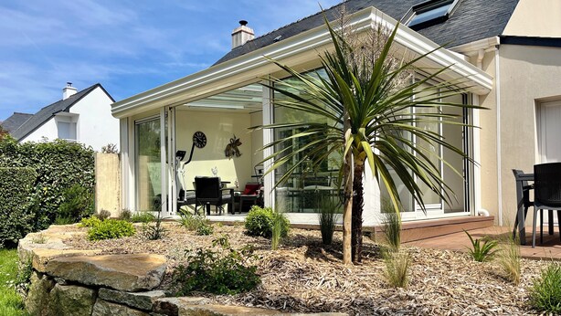 A house with a patio area, stone wall, and a palm tree. - House / Villa - LA BAULE-ESCOUBLAC (La Baule-Escoublac)