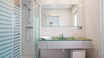 Shower, hair dryer, towels, toilet paper