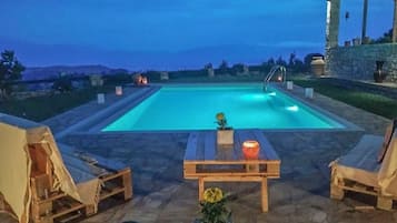 Relax by the pool surrounded by a serene atmosphere and comfortable lounge seating.