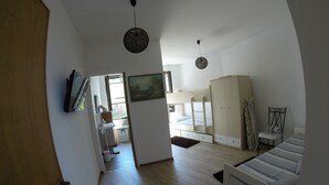 A bedroom with a bunk bed, a wardrobe, a desk, and a chair. - Exclusive penthouse overlooking the sea ....... with deserted beach under the house. (Alghero)