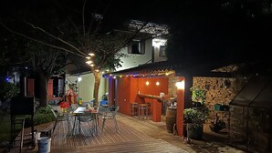 Eine Terrasse mit Sitzgelegenheiten im Freien, einer Bar und einer Steinmauer.