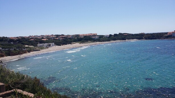 A coastal view with a sandy beach and clear blue sea. - The Lapwings (Calasetta)