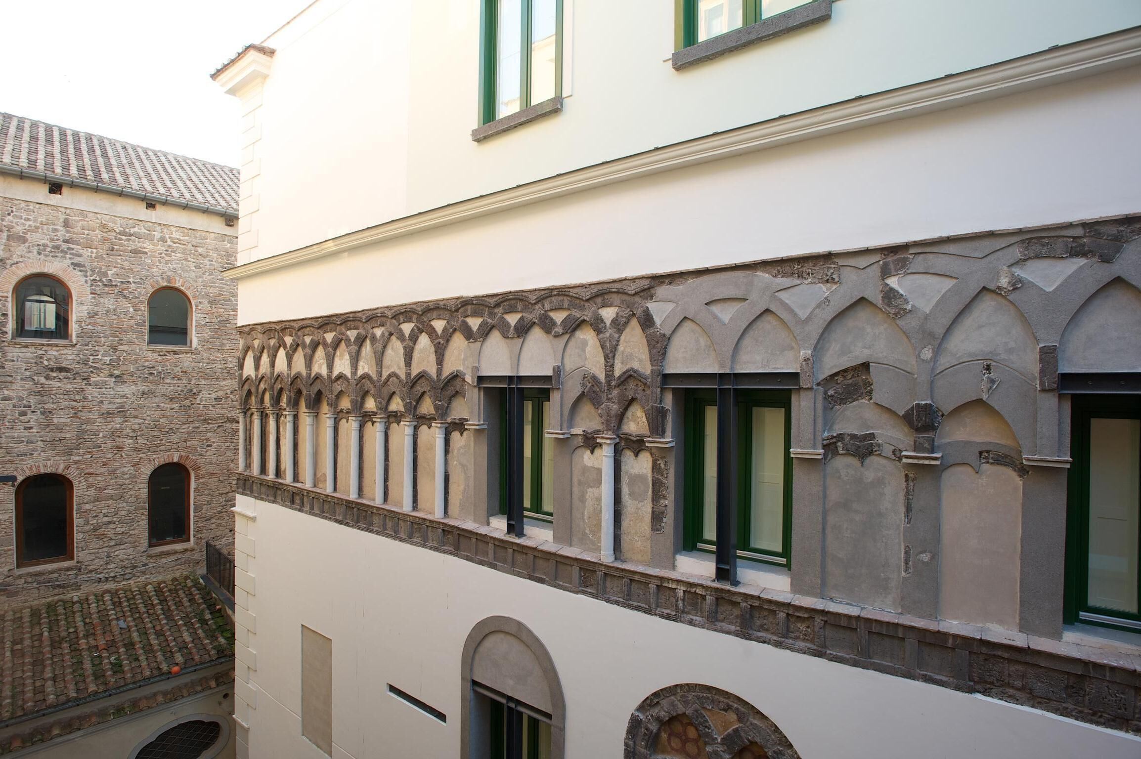 A building with a stone facade and arched windows.
