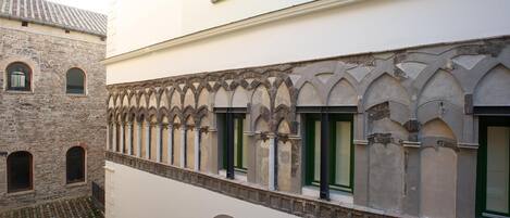 A building with a stone facade and arched windows.