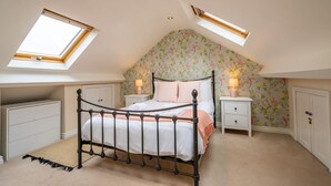 A bedroom with a skylight, a bed, a nightstand, and a wardrobe. - Buckingham Townhouse -  a family break that sleeps 6 guests in 3 bedrooms (York)