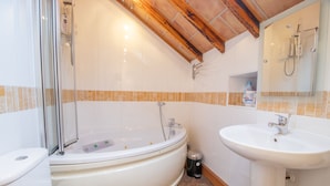A bathroom with a bathtub, toilet, sink, and shower. - Comfy Home.  No longer available on this site. No bookings accepted (Hamilton)