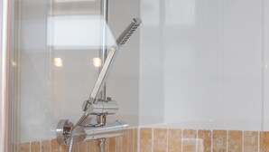 A chrome showerhead with a flexible hose and a pull handle. - Comfy Home.  No longer available on this site. No bookings accepted (Hamilton)