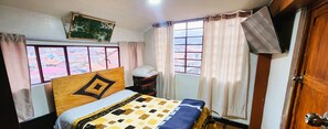 Cozy retreat with a bed and window offering a view of the surrounding area.