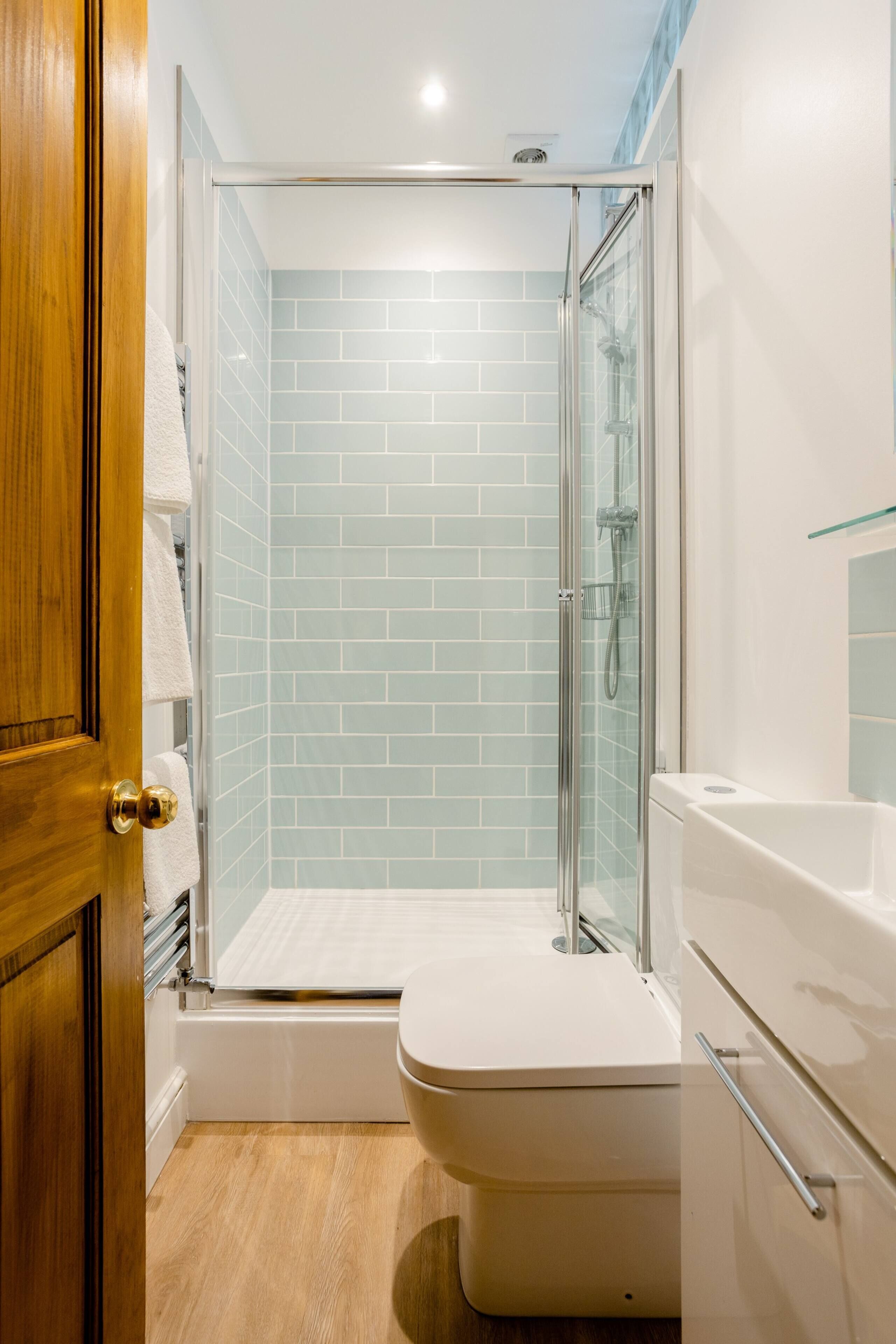 Separate bathtub and shower, hair dryer, towels, soap