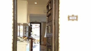 A hallway leading to a kitchen with a tiled floor and a door marked with the number 704. - Dream holiday in Carihuela (Torremolinos)