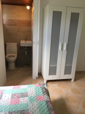 A bathroom with a toilet, sink, and a wardrobe. - Secluded Lovely 2 Bedroom Ground Floor Apartment  with WiFI  Pool and Garden  (Praia da Luz)