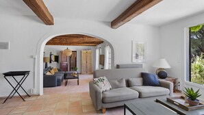 A spacious living area with a grey sofa, a coffee table, and a wooden ceiling. - Stunning property in the heart of Provence. Big pool area.. Fully ventilated (Vidauban)