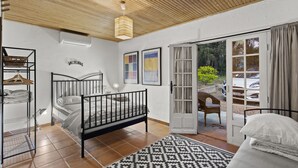A bedroom with a bed, a wardrobe, a desk, and a chair. There is a window with curtains and a view of the outside. - Stunning property in the heart of Provence. Big pool area.. Fully ventilated (Vidauban)