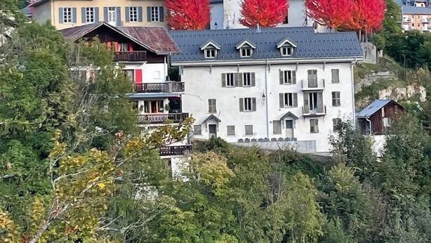 A large white building with a prominent tower, surrounded by trees with autumn foliage. - Winter/Summer holidays in St Gervais Le Bains Sleeps 4 (Saint-Gervais-Les-Bains)