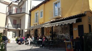 A street with outdoor seating at a bar named 'BAMBAR'.