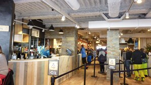 A café interior with a bar area, wooden flooring, stone accents, and hanging pendant lights. - Apartment/ flat - Cauterets (Cauterets)