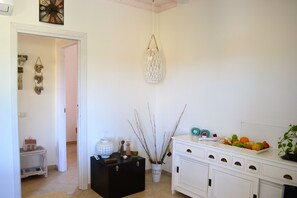Comfortable retreat with a clean, minimalist design featuring a dresser, storage box, and decorative vase.