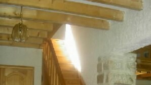 A wooden staircase with a stone wall and a door. - mansion - Fournels (Fournels)