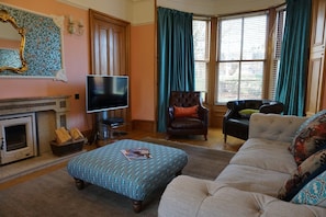 The sitting room has comfortable seating for 8, a wood-burning stove and Sky TV.