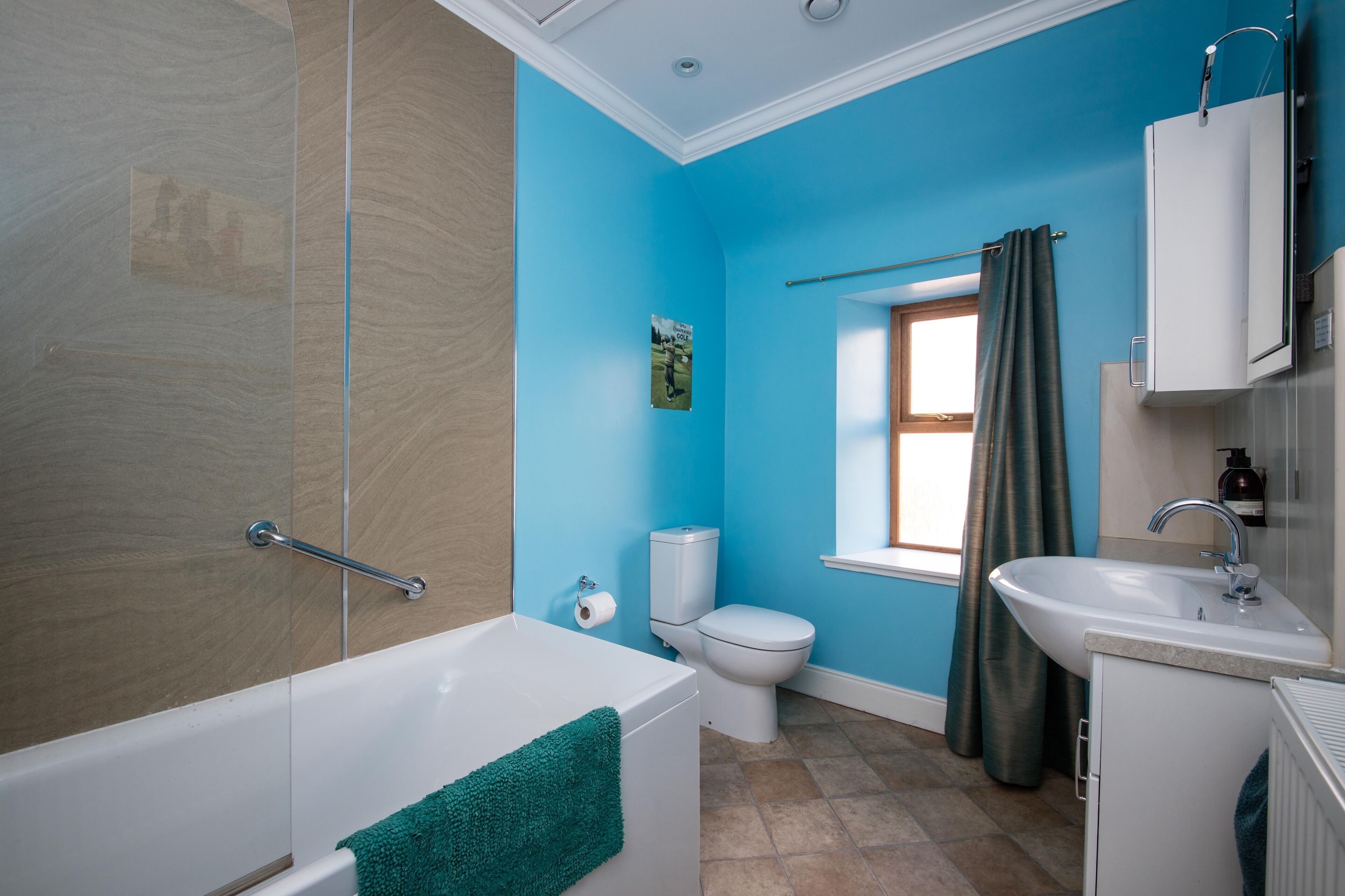 The family bathroom has a showerover the bath.