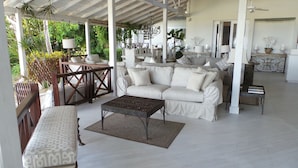 A covered outdoor seating area with a sofa, chairs, and a coffee table. - Very Spacious, Private, Open Plan Retreat. Pool And Stunning Views Of West Coast (Saint Peter)
