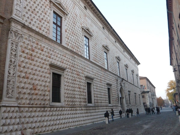 A historic building with a patterned facade and large windows.