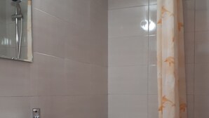 A bathroom with a toilet, sink, and shower. - Katerina Apartments ,( 1 ) One-Bedroom Apartment with Balcony (Kalamata)