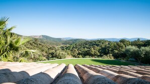 A terrace with stone balustrades overlooking a lush green landscape with trees and distant hills. - Panoramic view Grimaud (La Garde-Freinet)