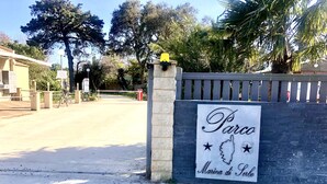 A gated entrance with a sign reading "Parco Marina di Sorso."