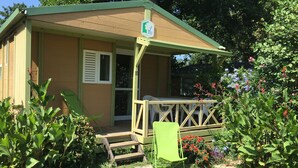 A small, single-story building with a porch and a wheelchair-accessible ramp.