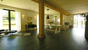 A spacious living area with a dining table, chairs, and a sofa. - The ground floor of a beautifully renovated luxury farm! (Erlecom)