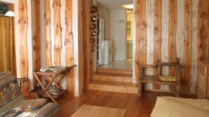 A wooden interior with a sofa, a chair, and a small table. - Very comfortable apartment in the center of the resort- at the foot of the slop (Valloire)
