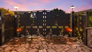A gated entrance with a stone pathway leading to a building. - Country House Casale dei Gelsi Entire property including swimming pool for private use (Castiglione in Teverina)