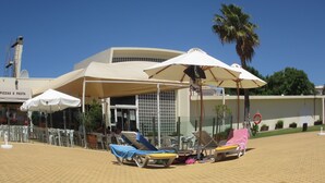 A beachside restaurant with outdoor seating and umbrellas. - Lovely 2 bedroom apartment with air con and excellent communal pool & bar (Fonte Santa)