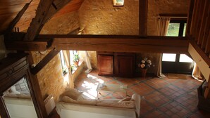 A rustic room with a wooden ceiling, a bed, a fireplace, and a window with curtains. - "Les Mirabelles"  in deep rural France - (Gardonne)