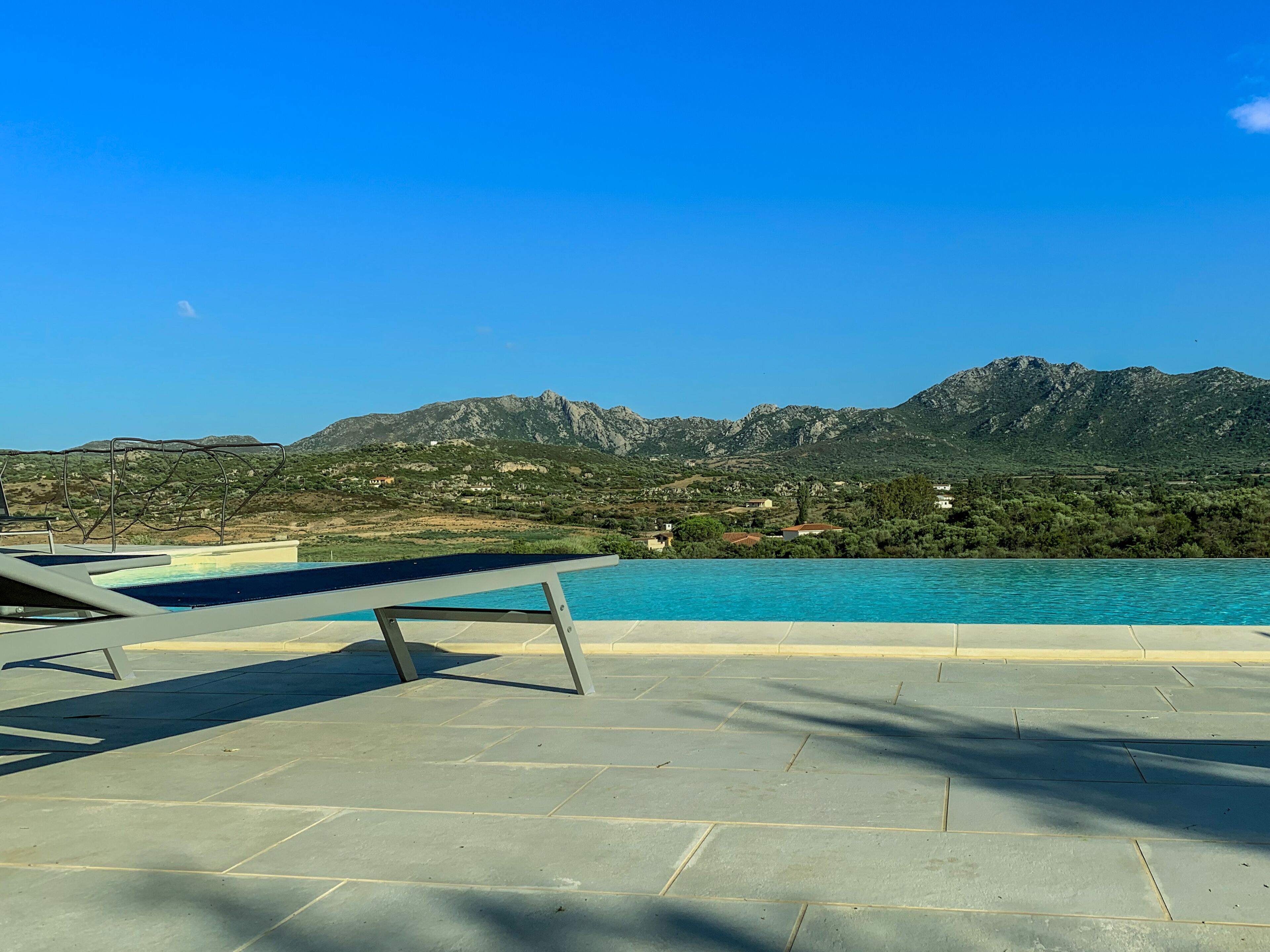 A swimming pool with a mountain backdrop.