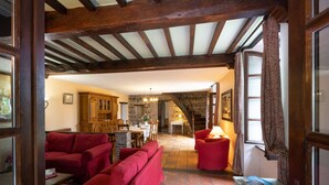 A cozy living room with red sofas, a stone fireplace, and wooden beams. - Superb 19th C. Farmhouse in extensive grounds, near Pyrenées, Pau and Lourdes (Caixon)