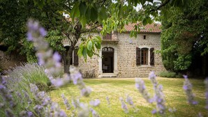 A stone building with a central entrance, surrounded by a well-maintained lawn and flowering plants. - Superb 19th C. Farmhouse in extensive grounds, near Pyrenées, Pau and Lourdes (Caixon)